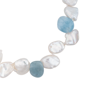 A close-up of an aquamarine and keshi pearl bracelet with magnetic clasp