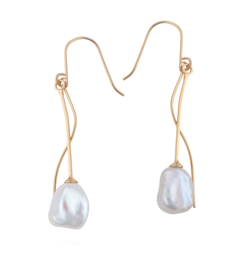 A close- up image of a white keshi pearl earring on a 9ct gold setting.