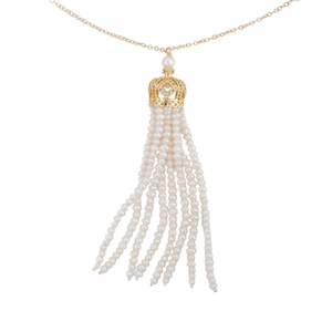 A close-up of a long gold and white freshwater cultured pearl tassel necklace