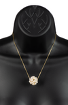 An image of a white snowball pearl cluster necklace on a gold chain on a black mannequin