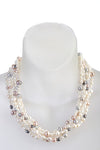 An image of a white freshwater cultured pearl five-strand necklace with white, gray, and pink pearls on a white mannequin